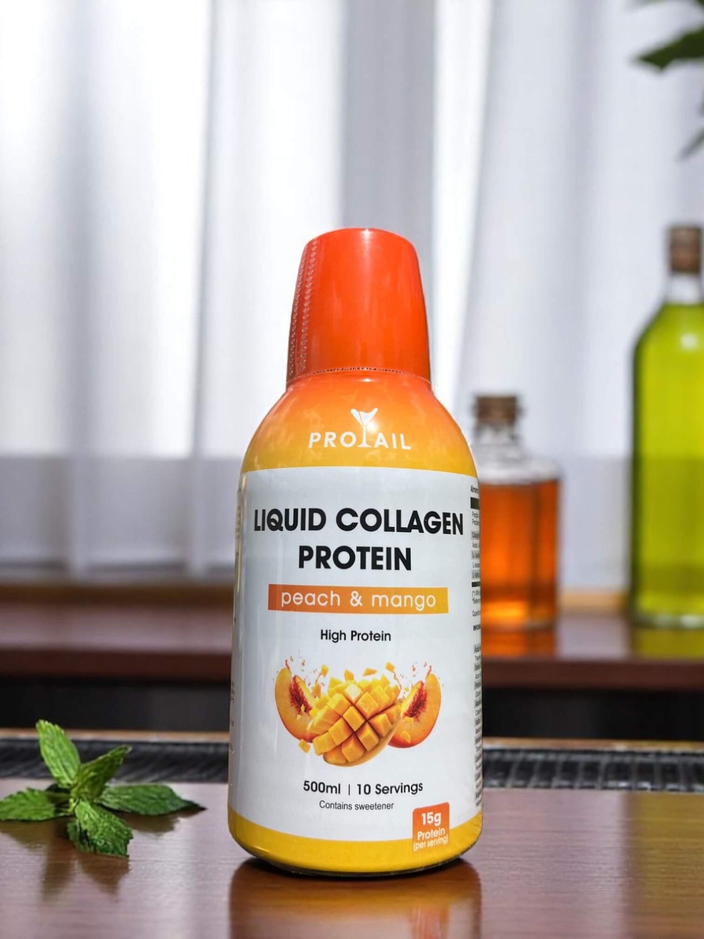 Bottle of Protail Liquid Collagen Protein with peach and mango flavor on a wooden surface. Ready t o make cocktails.