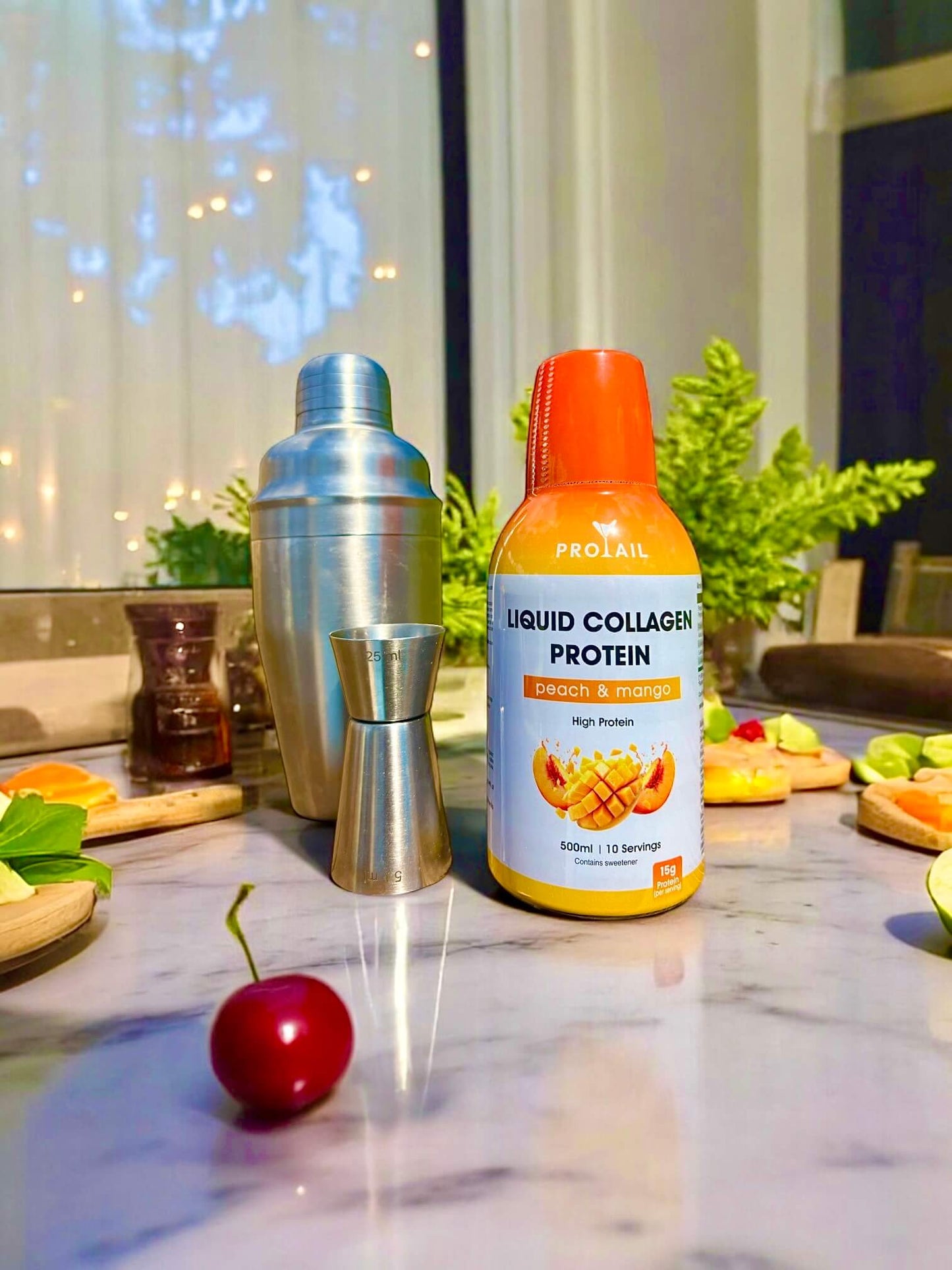 Bottle of liquid collagen protein on a kitchen counter with ingredients and kitchen tools.