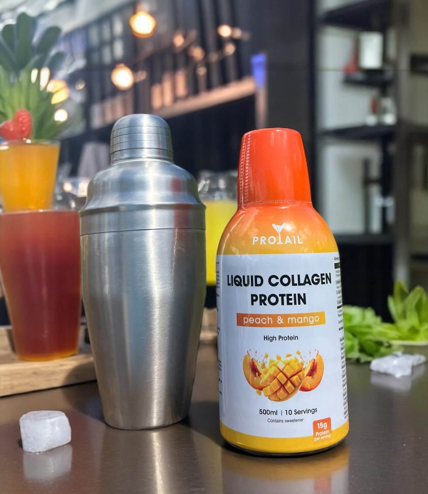 Protail Liquid Collagen Protein bottle with a cocktail shaker and drinks in the background.